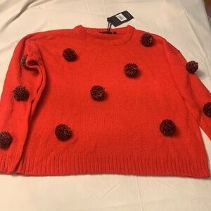 Red pom pom sweater